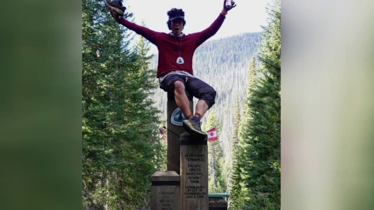 Jordan Leffler celebrates after completing the Pacific Crest Trail