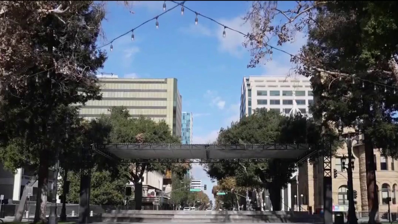 Plaza de San Jose sign with historic architecture in background